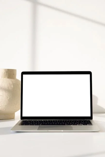 A modern workspace featuring dual computer monitors displaying web design projects, emphasizing technology and productivity.